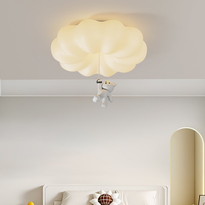 Bear ceiling light lit against a pale wall above a white crib