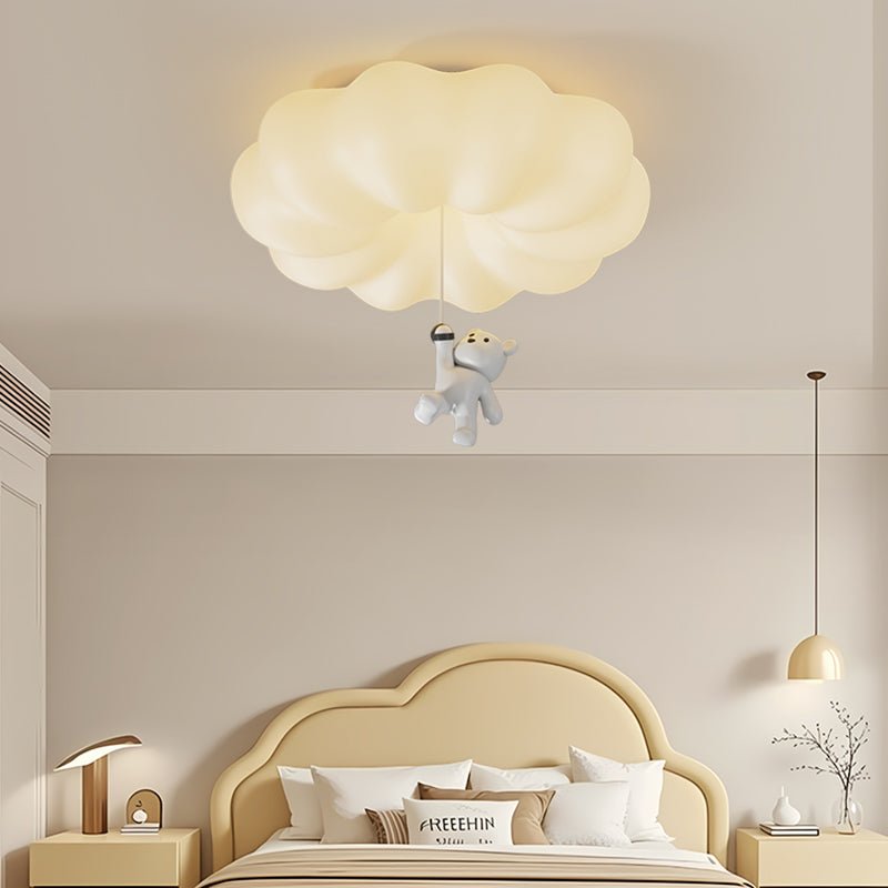 Cloud bear ceiling light in a child room with an arched headboard and a table lamp