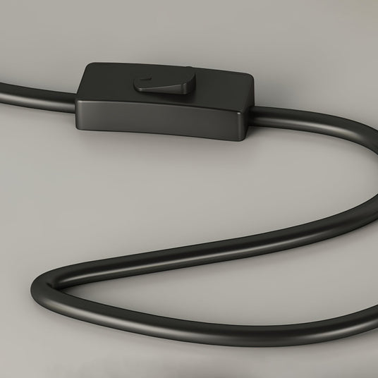 Close view of the inline push button switch on the black power cord