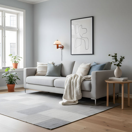 Oak wall lamp on a living room wall above a sofa and a framed print