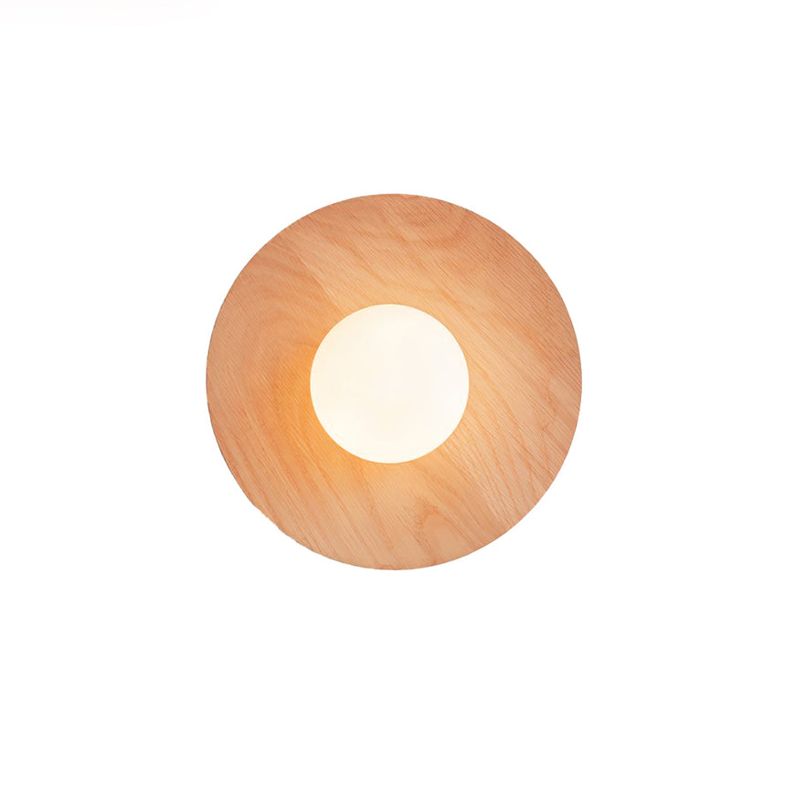 The smallest oak disc with the frosted globe lit warm at its center