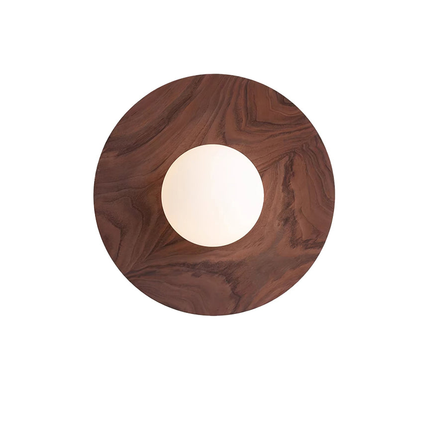 Black walnut disc seen from the front, the white globe unlit at its middle