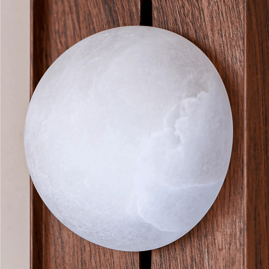 Close view of the white alabaster orb showing the cloudy figure of the stone