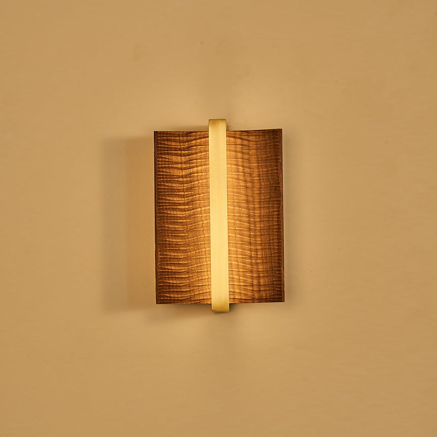 The fitting lit with a brass center bar, the slot glowing behind it
