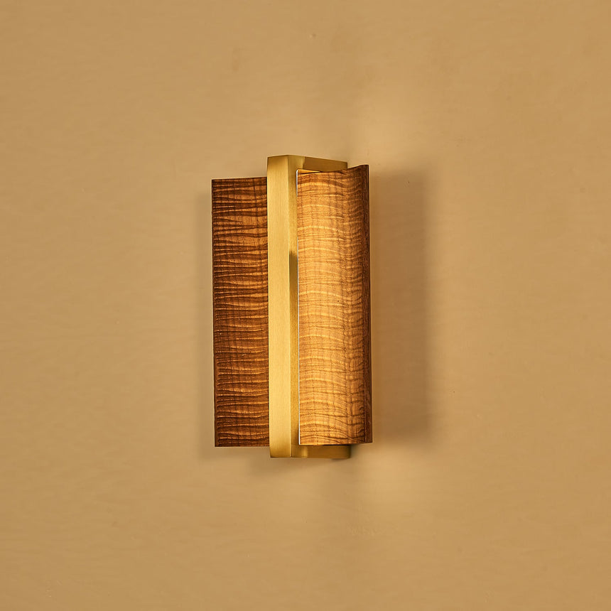 The dark wings with a brass bar, unlit, seen against a warm ground