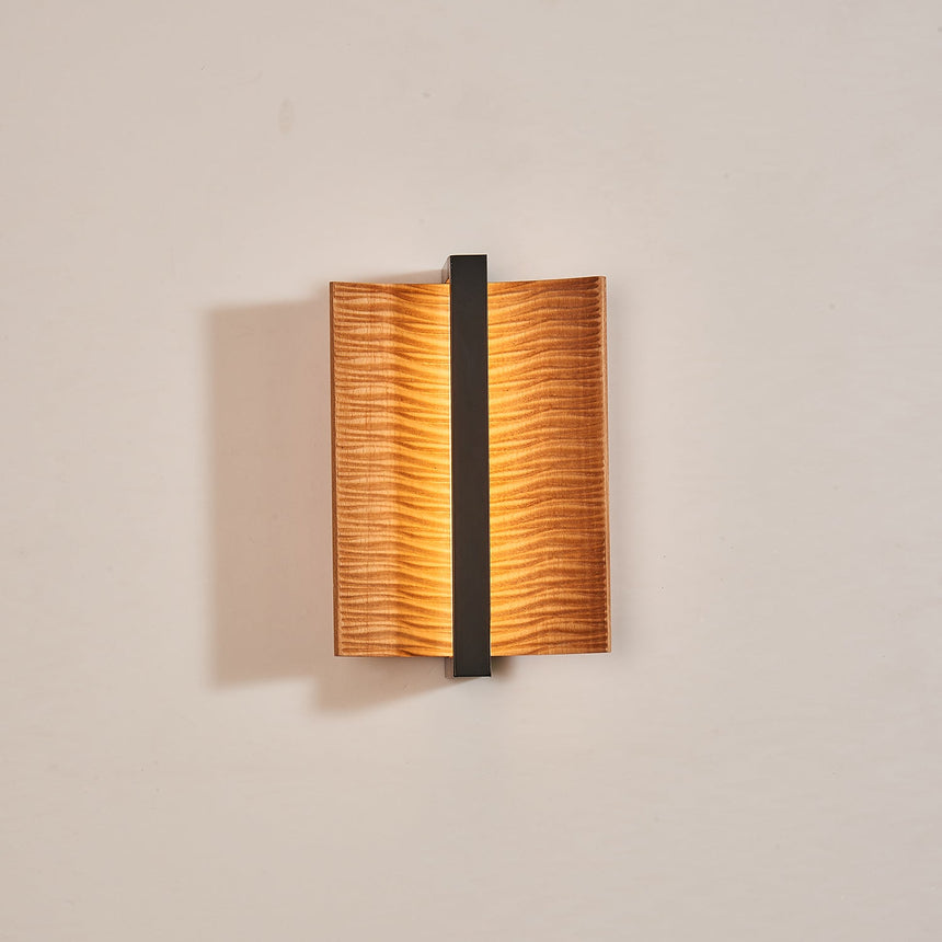 The pale wood version lit, the two wings curling forward off the wall