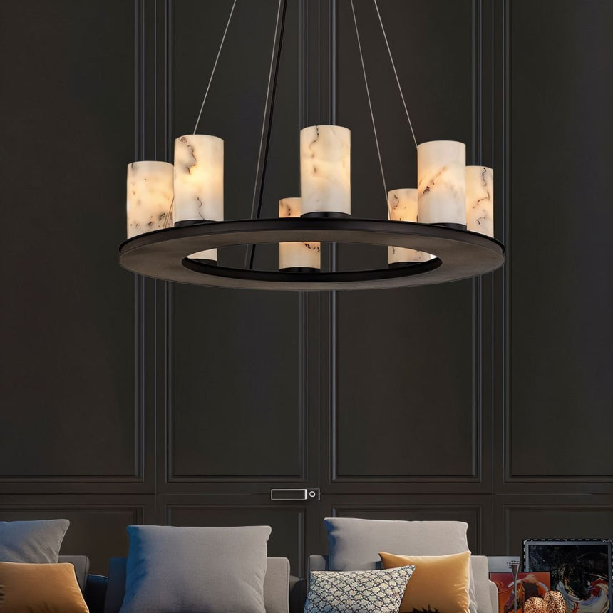 The lit ring in a dark room above a sofa with cushions and paneled walls