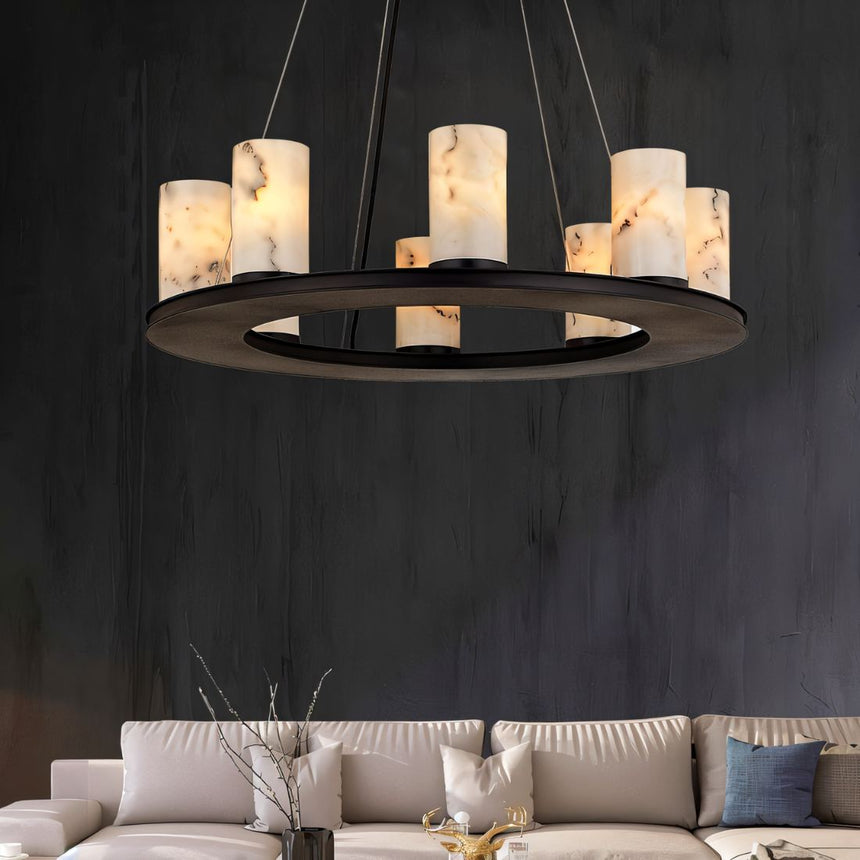 The lit ring against a dark wall above a pale sofa and a tall vase