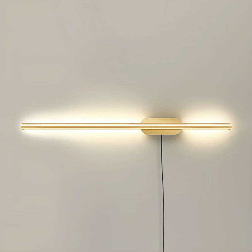 The slim gold profile lit, a narrow band of light across a pale wall