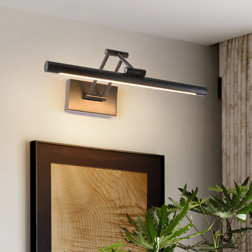 Black bar lit above a framed wood panel artwork beside a plant in a pale room