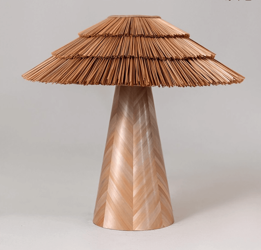 Boho table lamp in natural straw seen from the front, plain background