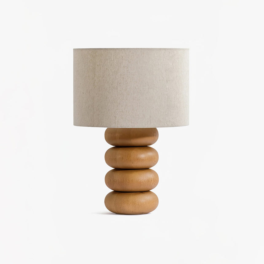 Stacked wood sphere lamp seen from an angle with an off white drum shade