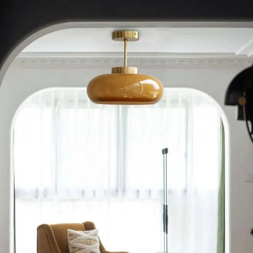 The yellow dome lit beside an arched window with an armchair below it