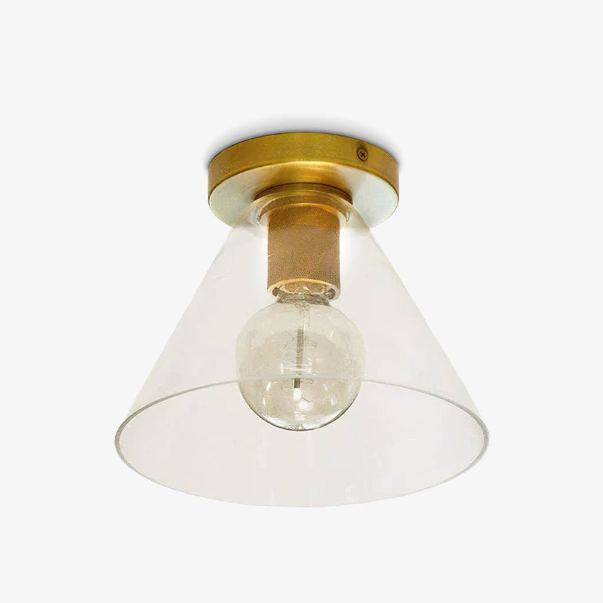 Brass ceiling light with a cone shade and a filament bulb on a pale backdrop