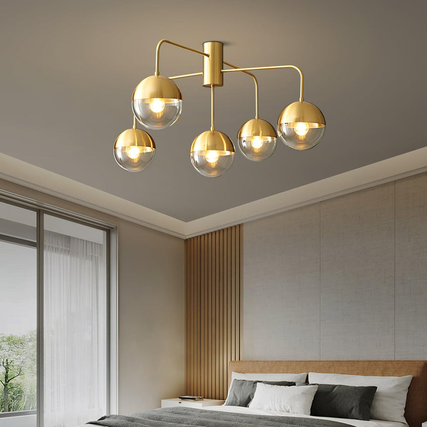 Five globe brass ceiling light in a bedroom with slatted wall panels