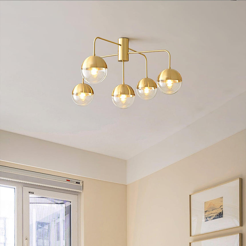 Five globe brass ceiling light on a white ceiling near a balcony door