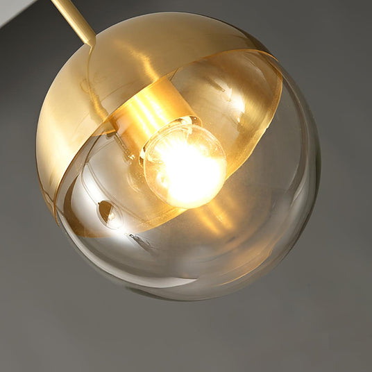 Close view of a lit globe with the bulb visible through the clear glass