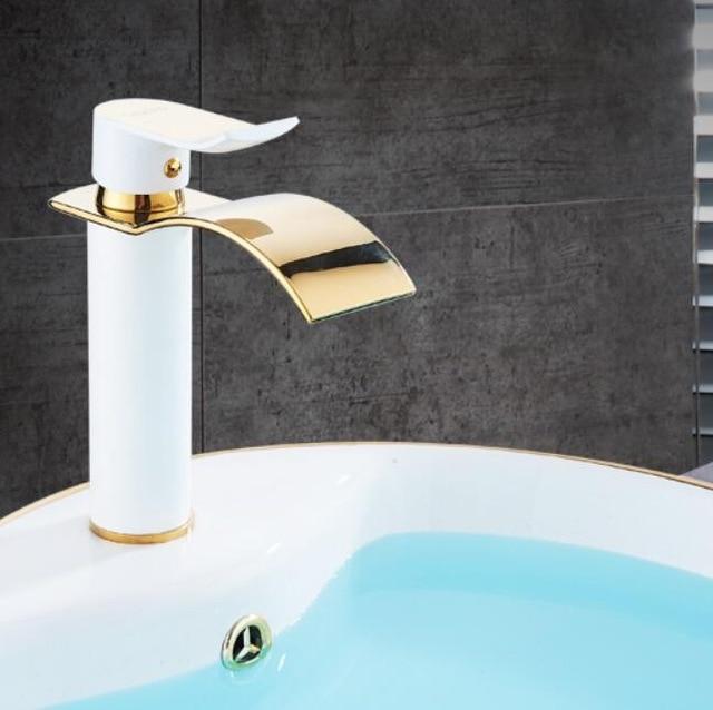 Gold and white waterfall bathroom faucet installed in a bathroom setting