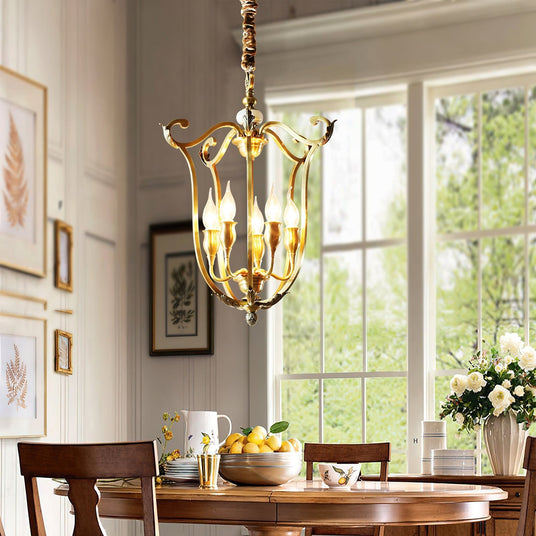 The scroll frame lit above a round dining table with fruit, flowers and a bay window