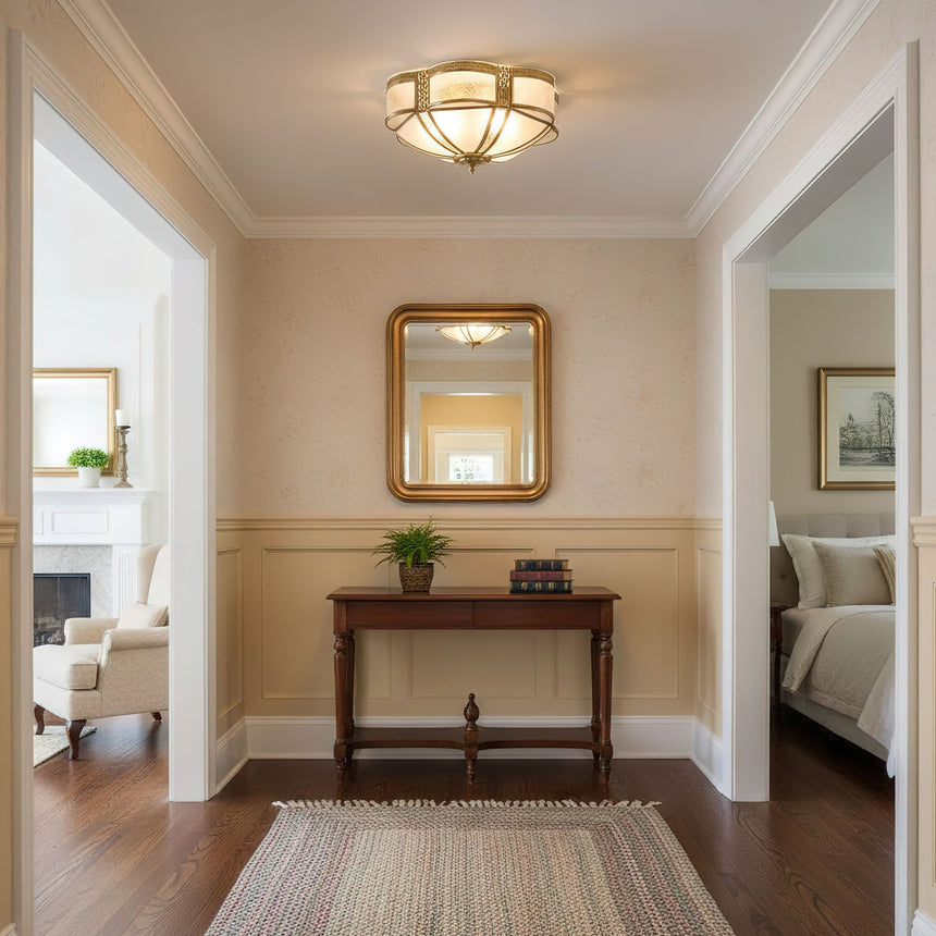 Brass and milk glass ceiling light in a hallway with a gilt mirror