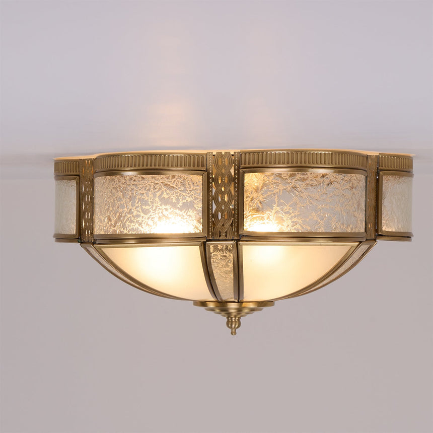Brass and milk glass ceiling light seen from below, unlit