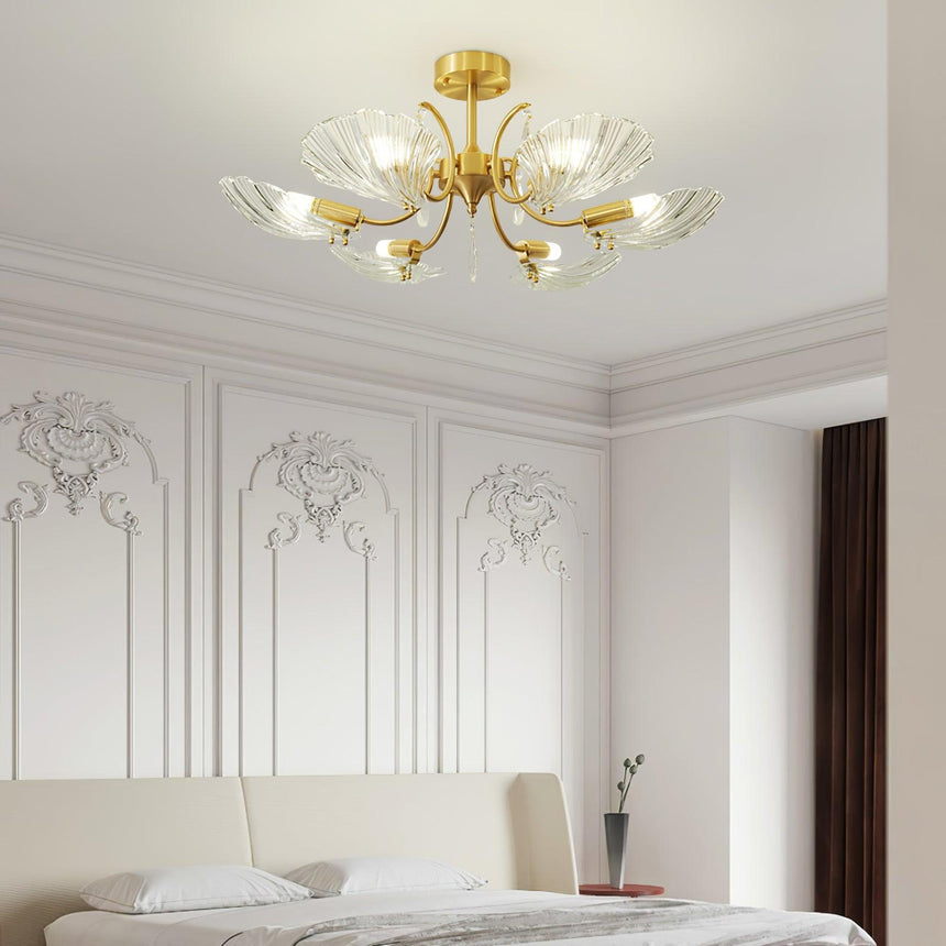 Shell shade ceiling light above a bed in a room with paneled walls