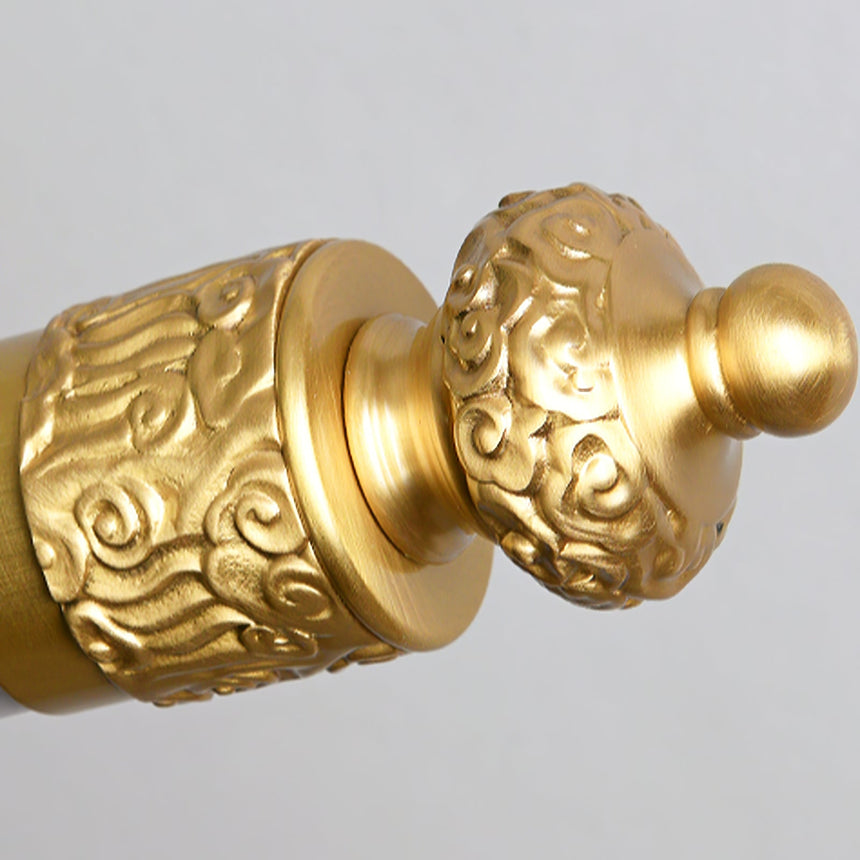 Close view of the turned finial and the cast rings at the end of the tube