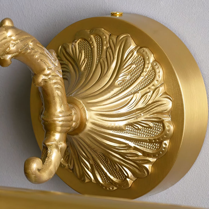 Close view of the cast shell plate and the scrolled arm rising from it