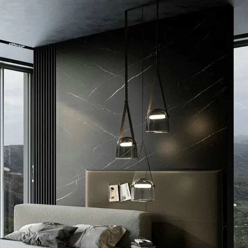 Two shades hung beside a bed in a room with a dark stone wall