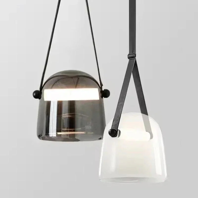 A smoke and a white bucket shade hung side by side on leather straps