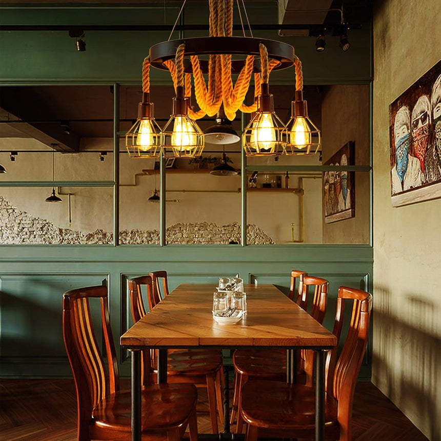 Chandelier lit above a long wood table with chairs on both sides