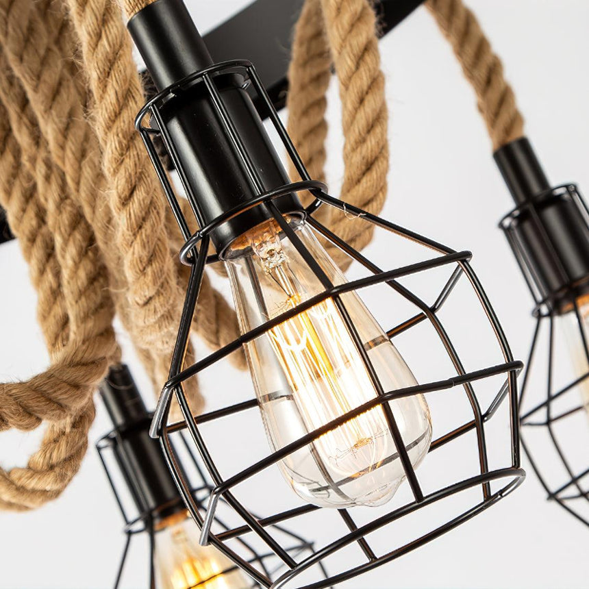 One black wire cage with a filament lamp burning inside it