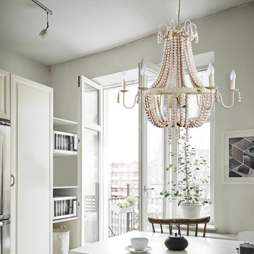 Lit beside open glazed doors with a bookcase and a round table behind