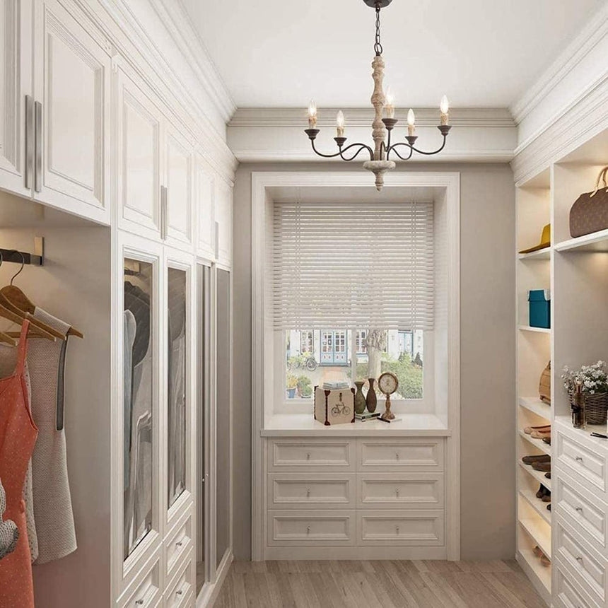 Hung in a dressing room lined with open shelves and drawers in front of a shuttered window