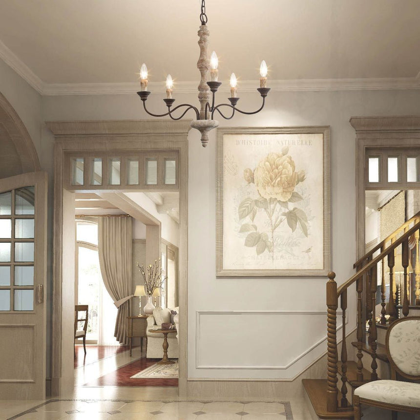 Hung in an entry hall in front of a framed print with a staircase and open doorway behind