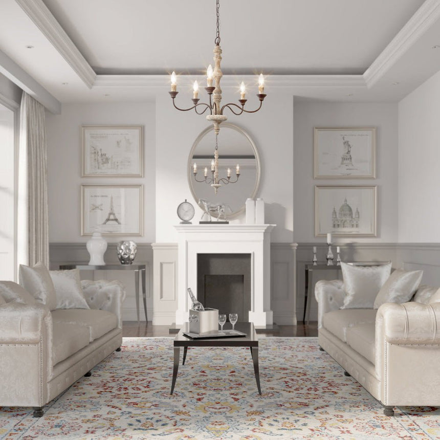 Seen from the doorway of a gray living room with a fireplace, two sofas and a patterned rug