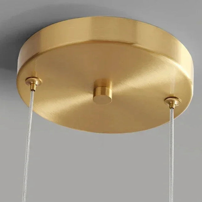 Close view of the brass ceiling plate and the cords