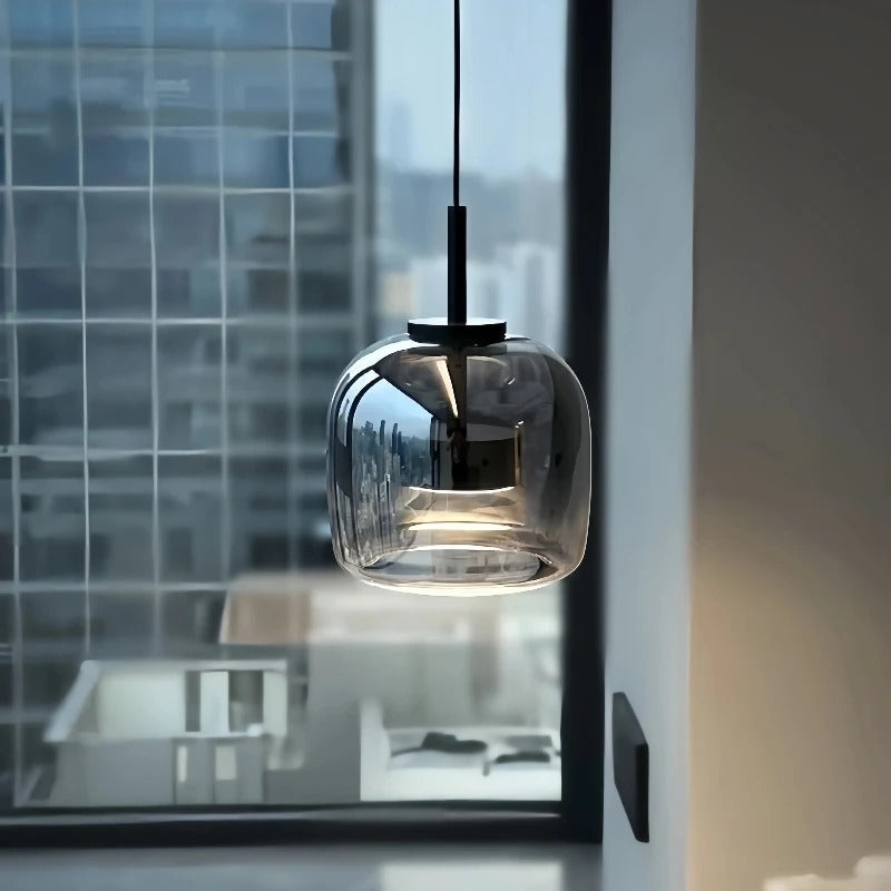 Smoke gray glass shade hung beside a tall window