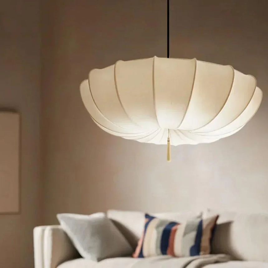 Scalloped cloth shade above a sofa with striped cushions