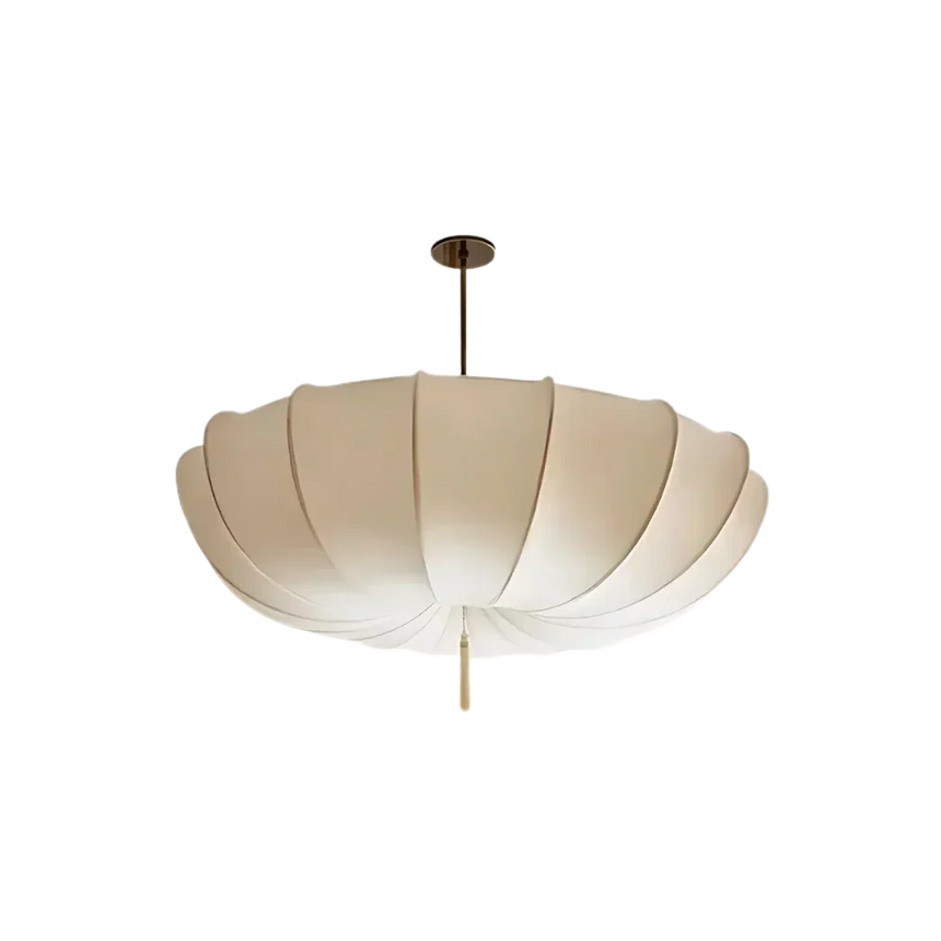 Scalloped cream cloth shade photographed against a plain gray ground