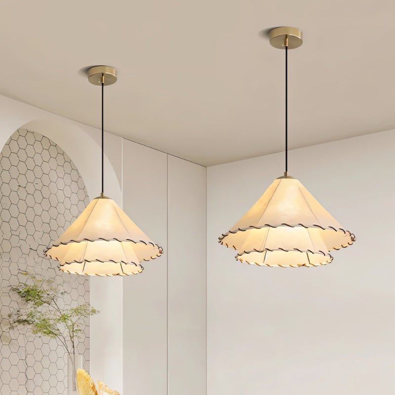 A pair of the cone shades lit against a white hexagonal tiled wall