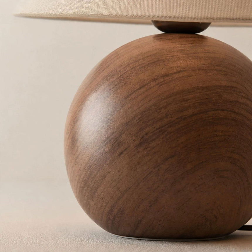 Close view of the wood grain finish on the ceramic orb base