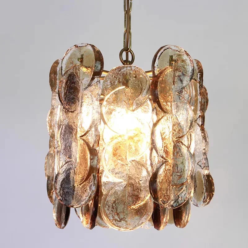 Close view of the overlapping amber glass petals on their metal frame