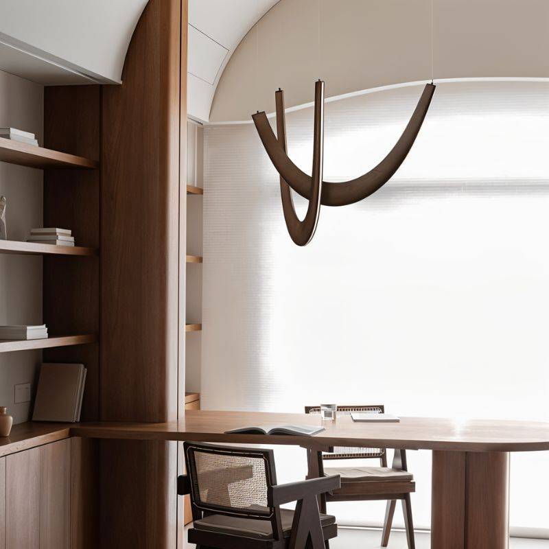 The dark arcs above a wood desk and chair beside built-in bookshelves