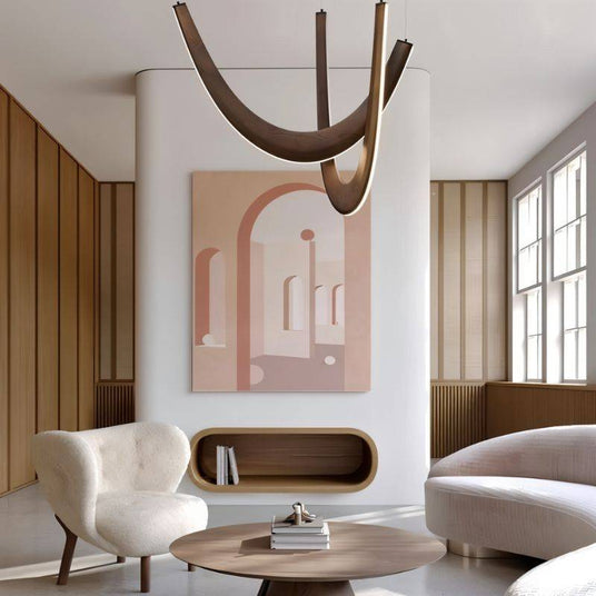 The dark arcs lit in a living room above a round coffee table, armchair and framed artwork