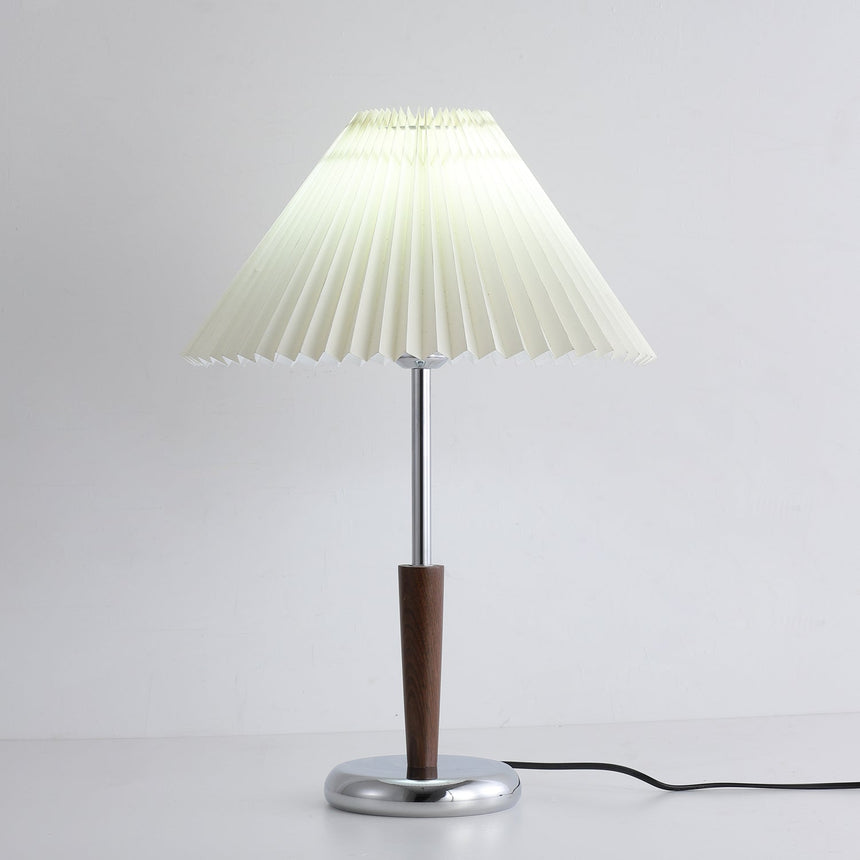 Chrome table lamp showing the pleated shade above the slim stem