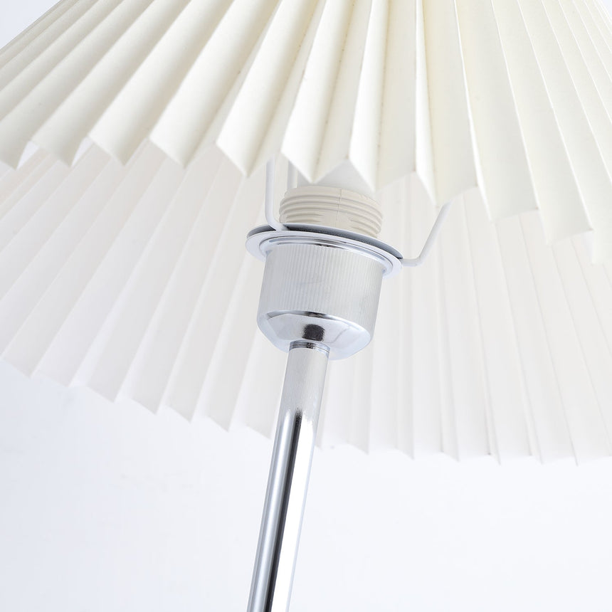 Close view of the socket and shade fitting under the pleated shade