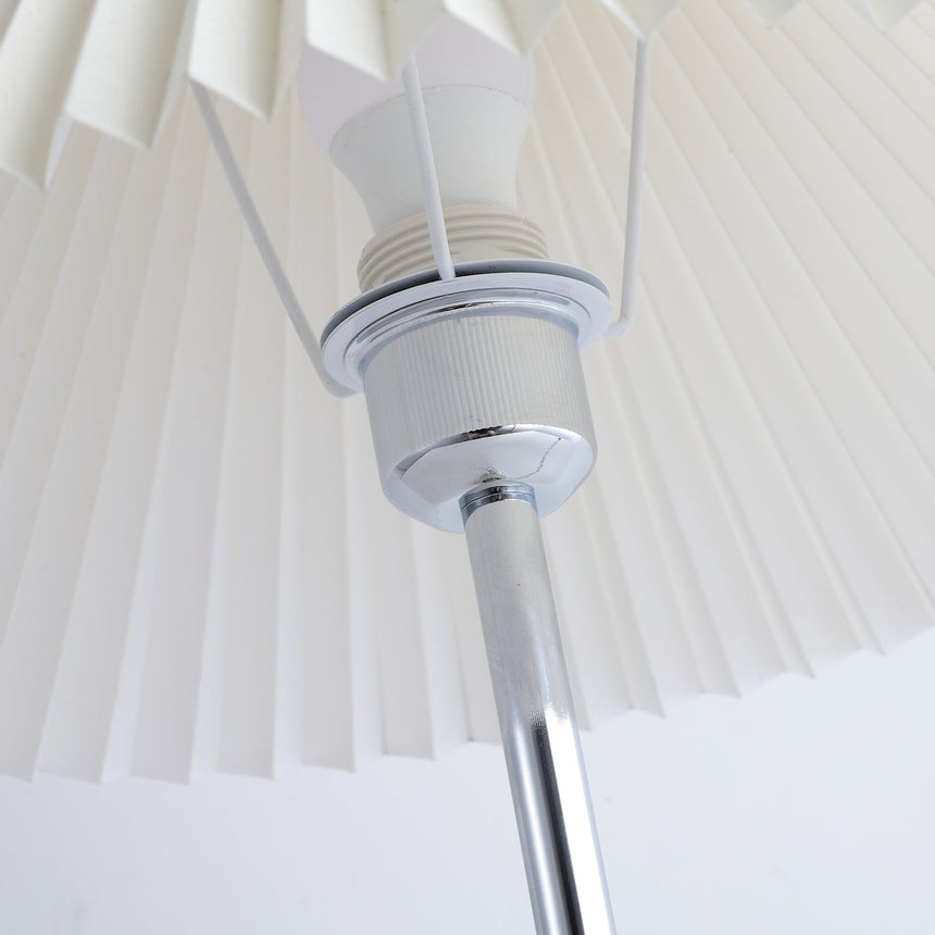 Close view of the socket and the chrome fitting inside the pleated shade