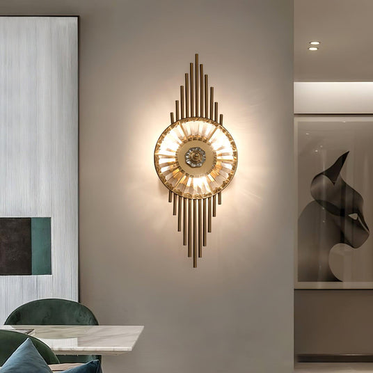 The sconce lit on a gray wall beside a dining chair and framed art