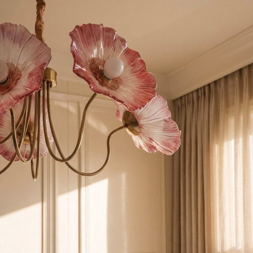 The red glass poppies lit close beside a long pale curtain